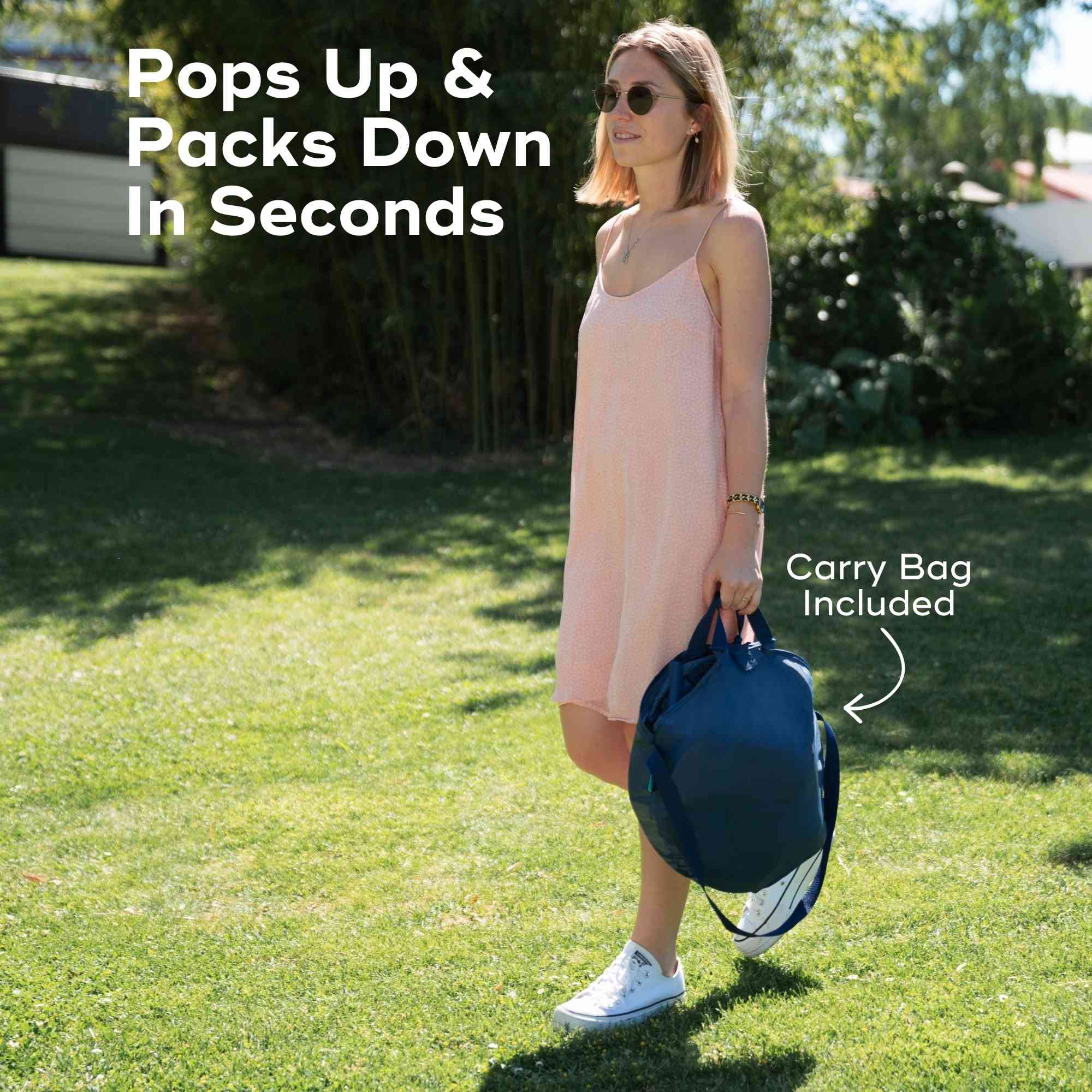 Woman holding a blue popup tent carrying bag with text indicating it pops up and packs down in seconds.